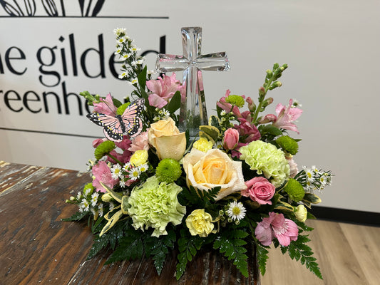 Spring-inspired glass cross